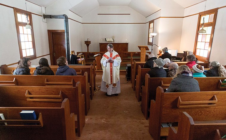 Citizen Photo by James Doyle. Vicar Alexis Saunders reads a passage on Sunday morning during the Jan. 5 service at St. Mark's Anglican Church in Woodpecker.