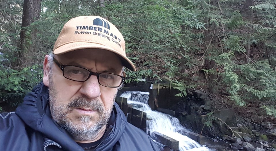 Marcus in front of a small waterfall