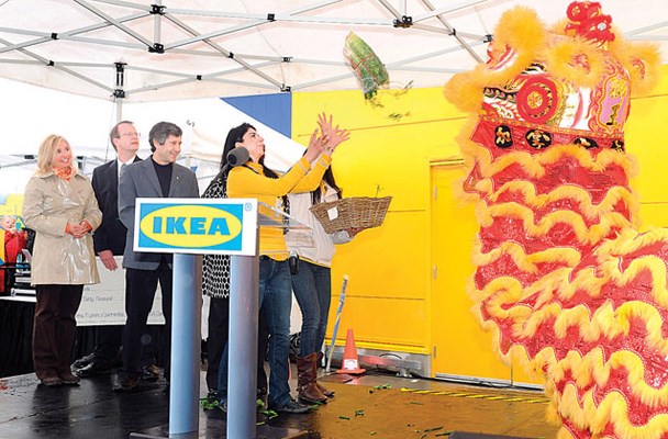 Store manager Maya Abdou catches the lucky cabbage spat out by the lion at IKEA's grand opening. On stage is IKEA Canada president Kerri Mulinaro (left to right), Tree Canada chair Timo Makinen and president Mike Rosen. Tree Canada received $30,000 from IKEA.