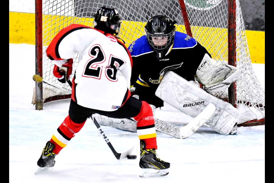 Langley peewee A Eagles netminder Kolton Maddocks stands his ground as New Westminster Royals’ Alexander Sy breaks in for a scoring opportunity during round robin action at the Herb House tournament last month at Queen’s Park Arena.