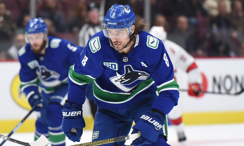 Chris Tanev skates up ice for the Vancouver Canucks.