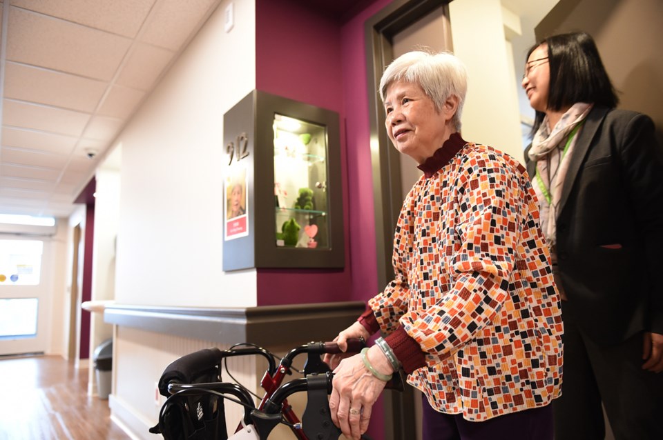 Doris Cheung, 75, leaving her new room at Villa Cathay Care Home in Strathcona. Behind her is care h