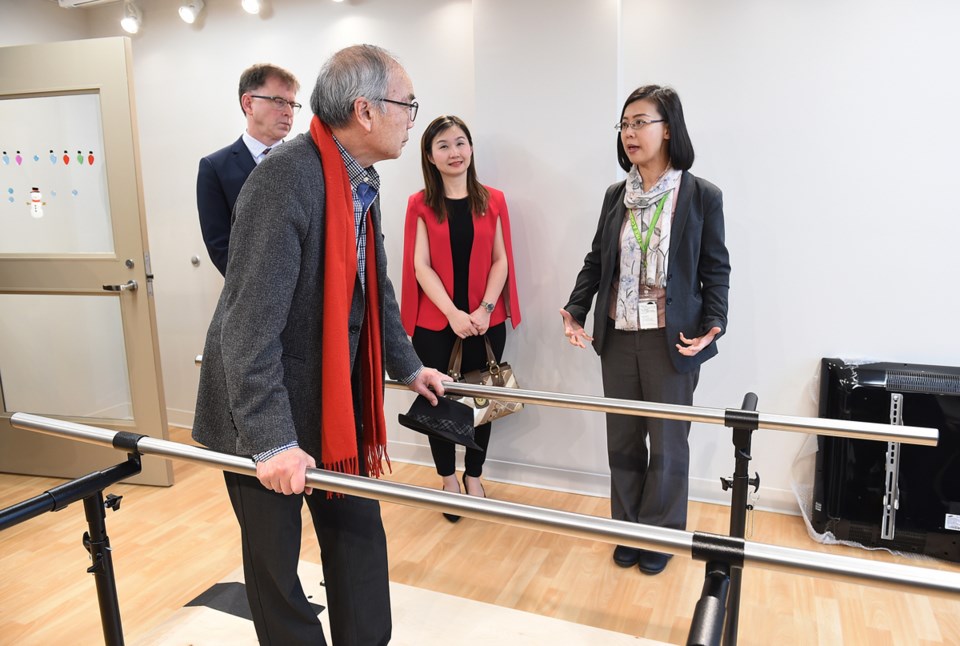 Executive director Szuchi Lee shows provincial politicians the exercise room. Photo Dan Toulgoet