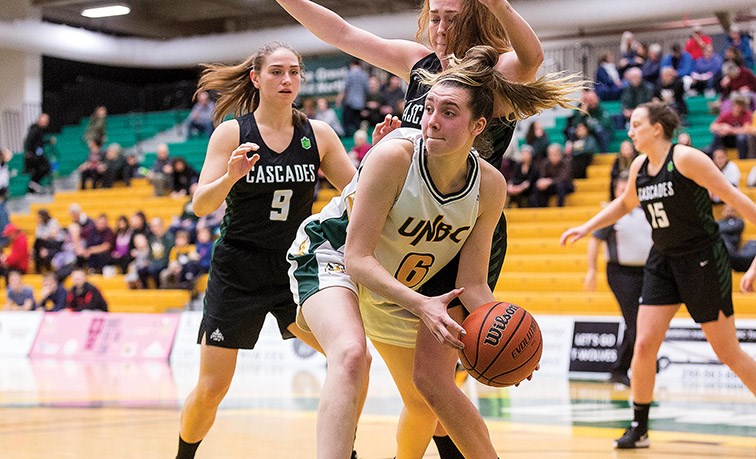Citizen Photo by James Doyle. UNBC Timberwolves forward Madison Landry looks to make a play with the ball against University of the Fraser Valley Cascades defenders Jessica Parker (#9) and Taylor Claggett (#10) on Friday evening at Northern Sport Centre.