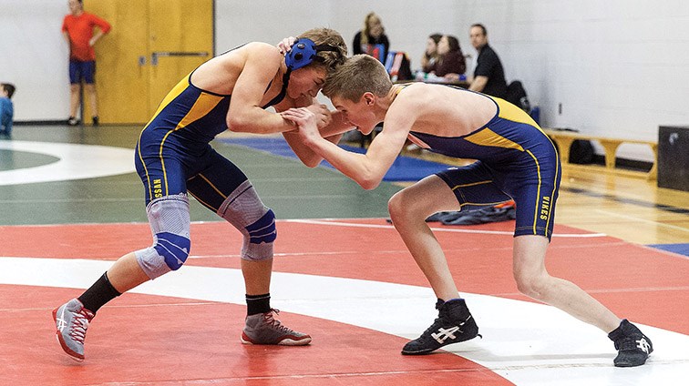 Citizen Photo by James Doyle. Emmit Giesbrecht of Nechako Valley Secondary School, right, grapples with Josh Zacharios of Nechako Valley Secondary School on Saturday afternoon at Kelly Road Secondary School’s gymnasium while competing in the 59kg weight class of the 39th annual Kelly Road Wrestling tournament.