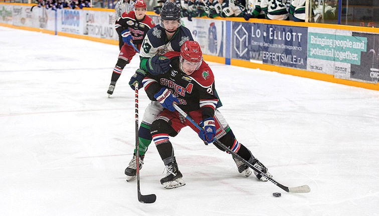 Citizen Photo by James Doyle. Prince George Spruce Kings forward Nicholas Poisson drives to the net while protecting the puck from Surrey Eagles defender Cade Alami on Saturday night at Rolling Mix Concrete Arena.