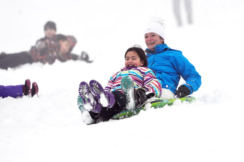 Petra Majmudar and 10-year-old Vanessa Stevens of Coquitlam toboggan on Burnaby Mountain.