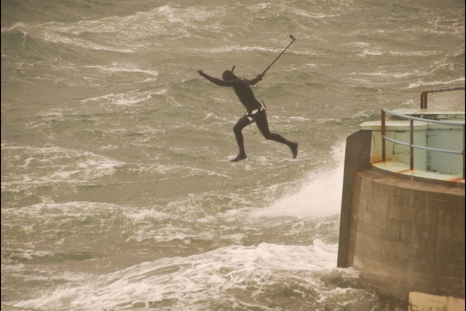 A man jumps from the seawall near Ogden Point on Sunday, Jan. 12, 2020. He had trouble getting out of the water and had to be rescued.