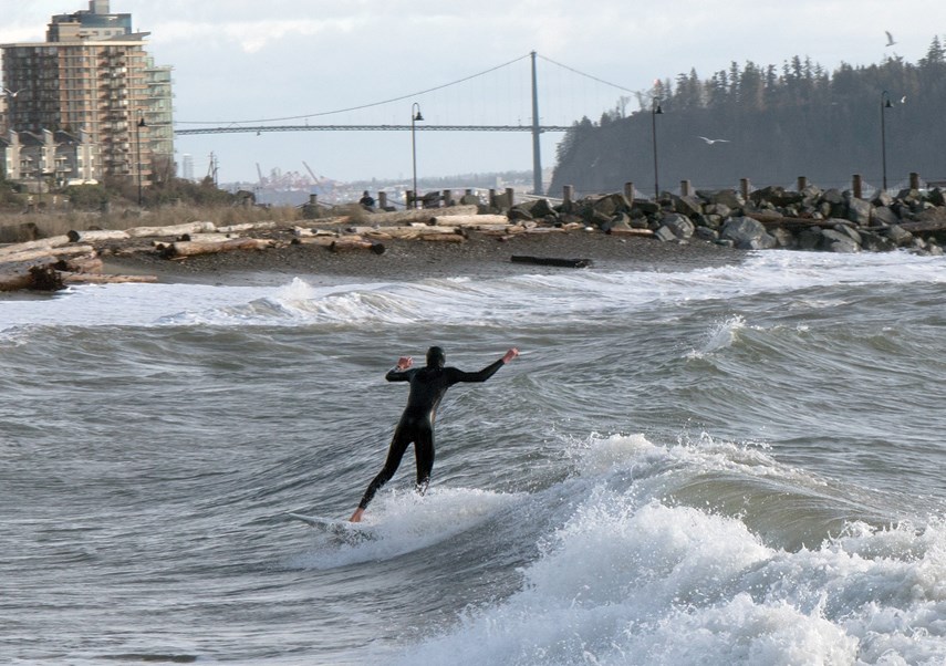A surfer catches a wave during a rare opportunity brought on by windy conditions in West Vancouver Saturday. photo supplied Darrion Kerr