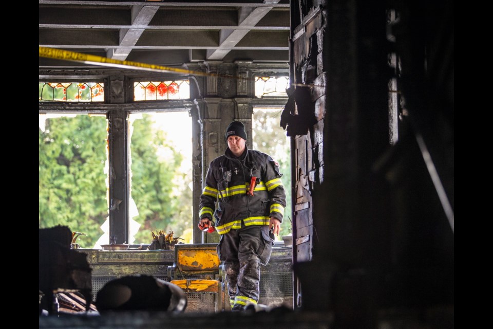 Acting Capt. Brent Hoeppner looks inside fire-damaged Spencer Castle on Thursday.