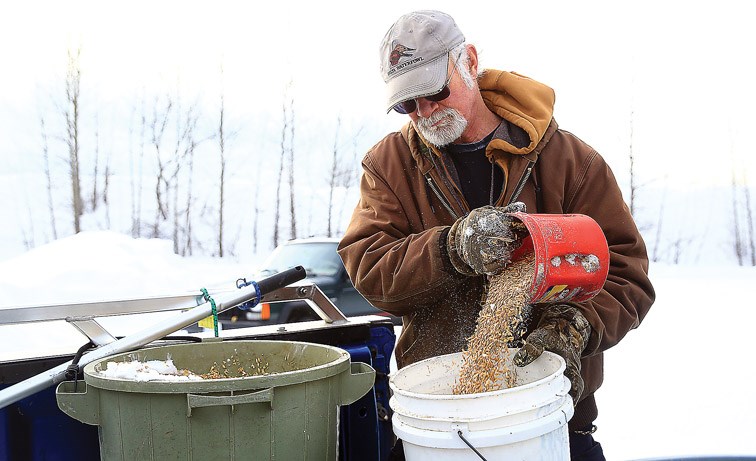 Brock Bailey prepares the feed he gives the ducks at Cottonwood Island Park on Sunday morning as he does every day throughout January and February.