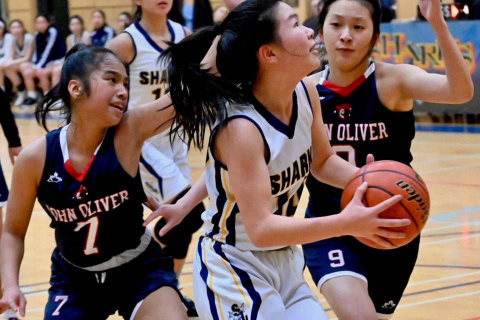 Steveston-London's Mina Chong drives to the basket for two of her game-high 26 points to lead her team past John Oliver in the girls title game at the 12th annual Bob Carkner Memorial Classic on Saturday night. Chong was named the tournament's MVP.