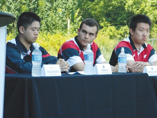 Andre Ho of Richmond sits with his table tennis team, Pierre-Luc Hinse and Wang Zhen.
