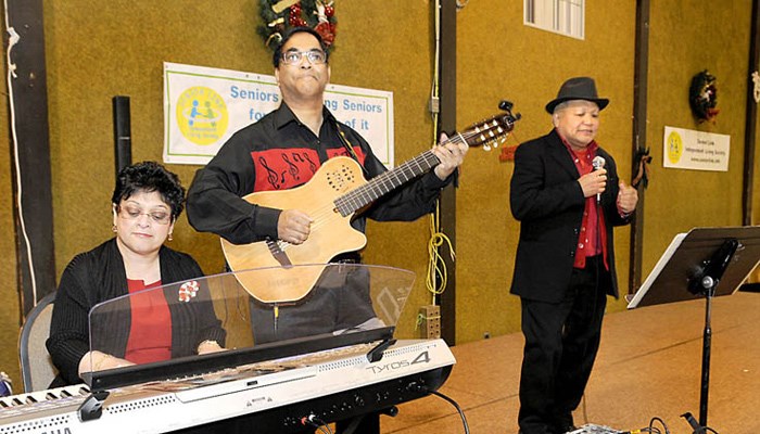 The annual Senior Link Society's Yuletide Buffet at the Richmond Alliance Church on Saturday afternoon was another sell out. The expected 120 guests enjoyed turkey and ham dinner while serenaded by the Music Variation Band, a Tai Chi demo by Brighouse Tai Chi and a visit from the big red man.