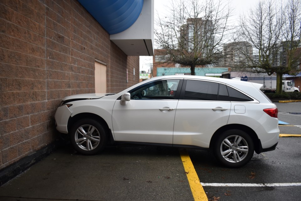 A white SUV crashed into a wall outside PriceSmart on Ackroyd Road Wednesday morning.