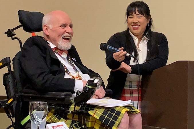Ian MacLeod, of Richmond, delivering his speech at last week's Robbie Burns Dinner, with the help of his niece, Alison MacLeod. Photo submitted