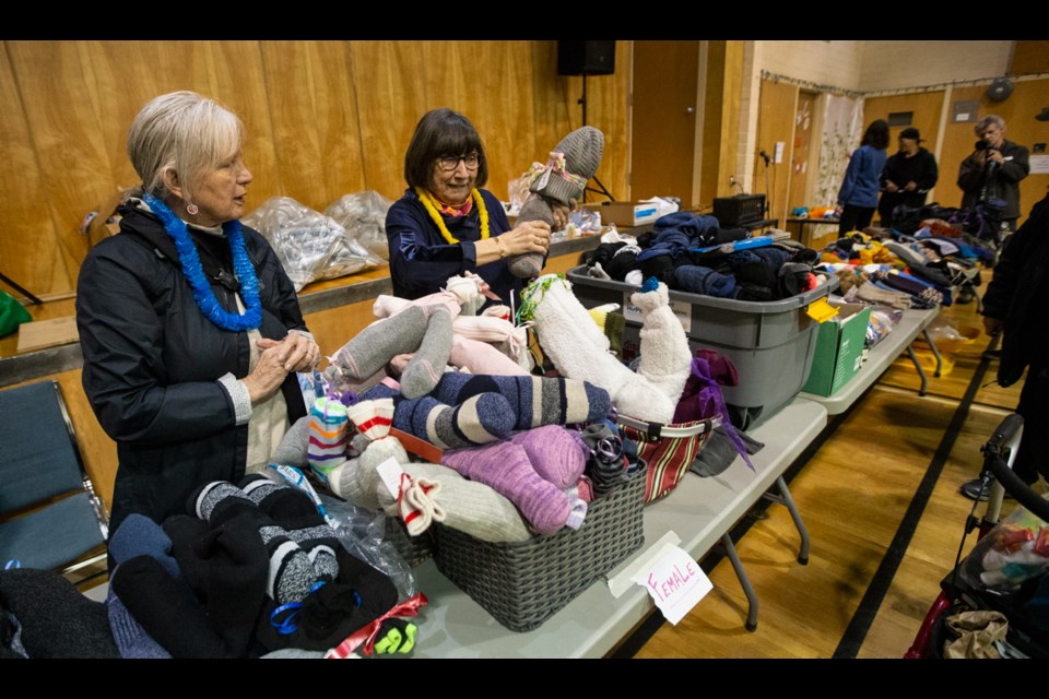Martha Stewart, left, and Janis Wheatley hand out clothing collected by Christ Church Cathedral at Kirk Hall during Project Connect, a one-day service and information fair for those experiencing homelessness and extreme poverty in Victoria.