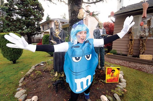 Jennifer Pavlovic dresses up as the M&M girl and tries to avoid being eaten by ghouls in her front yard on No. 2 Road south of Steveston Highway.