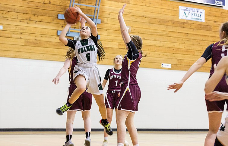 Citizen Photo by James Doyle. PGSS Polars player Julia Kreitz attempts a lay-up against a North Peace Grizzlies defender on Saturday afternoon at Kelly Road Secondary gymnasium during the Kelly Road Sr. Girls Invitational basketball tournament.