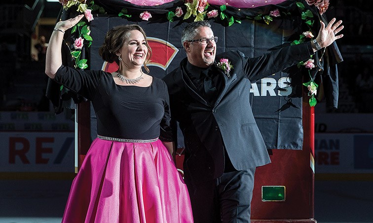 Citizen Photo by James Doyle. Newlyweds Chris and Amanda Holmes acknowledge the cheering crowd after getting married at centre ice at CN Centre on Saturday during the first intermission of the Prince George Cougars Vegas Night game.