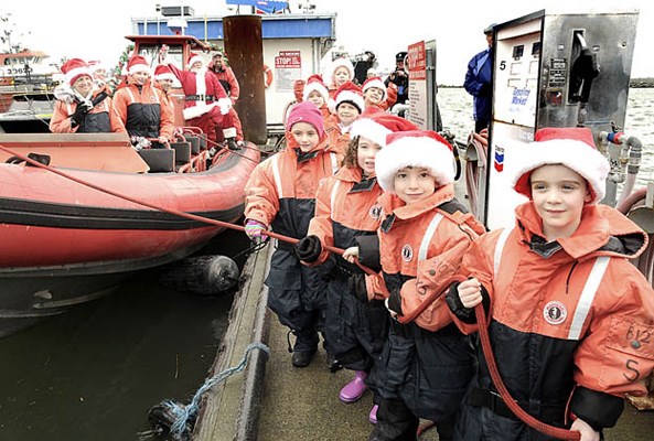A few hundred braved the rain, wind and biting temperature to greet the big jolly elf as he arrived by boat in Steveston on Saturday afternoon. Visitors to Steveston were treated to carolers, stilt-walkers, jugglers, horse and carriage ride and a chance to sit on Santa's lap and tell him all your wishes.