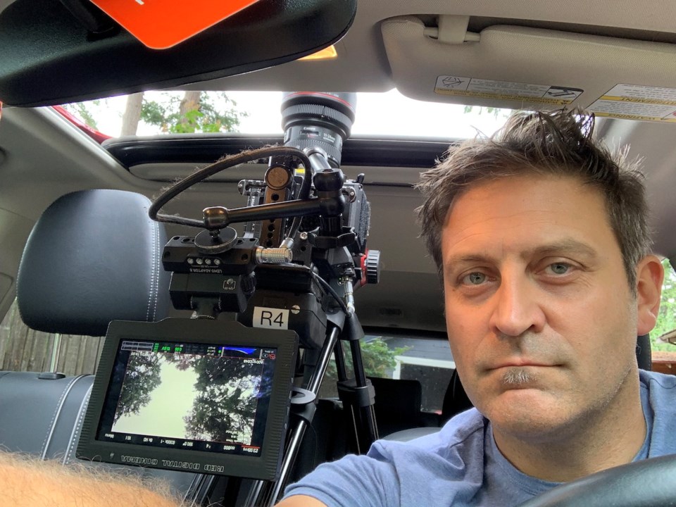 Chris Oben filming out the roof of the car.