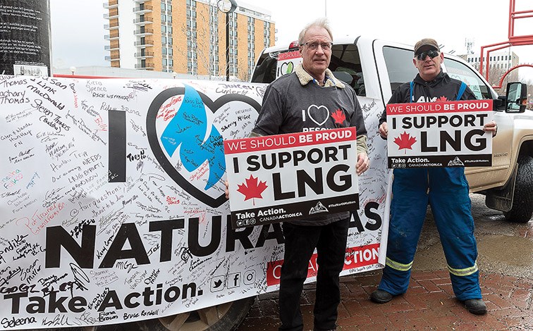 Citizen Photo by James Doyle. Richard Wittner, left, and Ian Fife hold up signs in support of resource workers during the The North Matters resource worker rally on Wednesday in Canada Games Plaza outside the 17th Annual B.C. Natural Resources Forum.