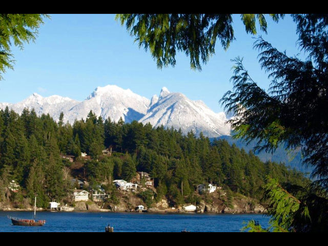 A view of Mannion Bay with the snow-covered North Shore peaks in the background.