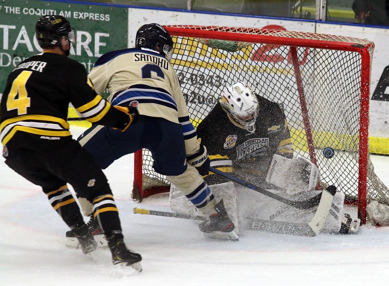 MARIO BARTEL/THE TRI-CITY NEWS
Coquitlam Express goalie Clay Stevenson makes a save on Langley Rivermen forward Chase Sandhu in the first period of their BC Hockey League game, Friday at the Poirier Sport and Leisure Complex in Coquitlam. Stevenson stopped all 29 shots he faces to earn a 5-0 shutout.