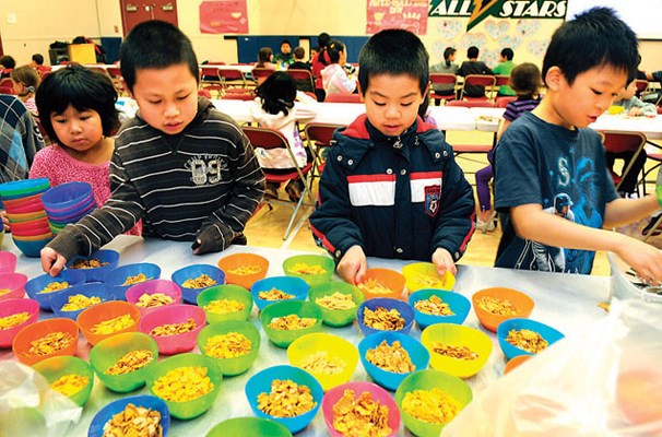 Students help themselves to colourful bowls of cereal Wednesday morning at the Breakfast Club.