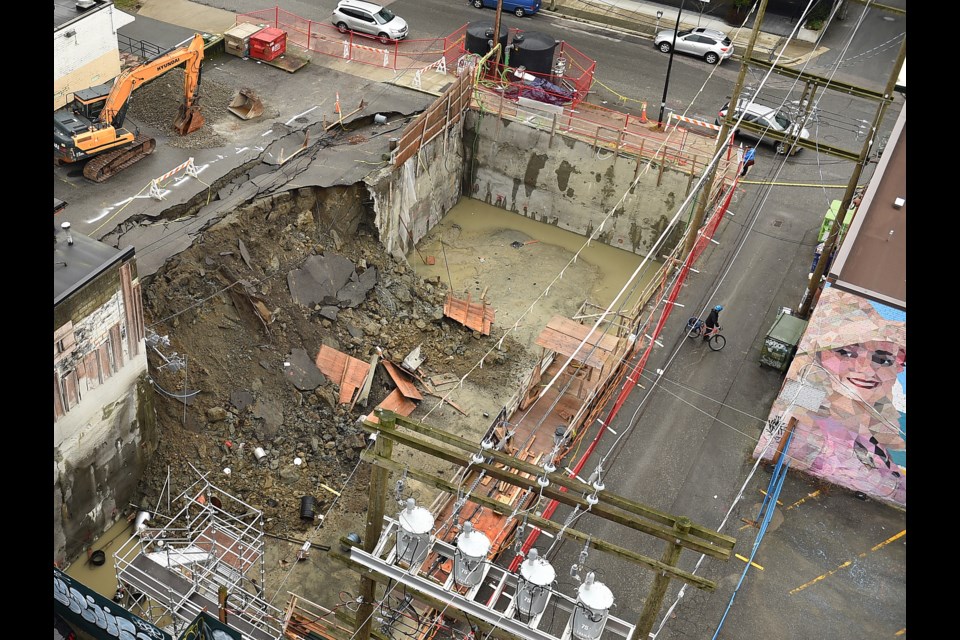 On Jan. 31, the retaining wall of a construction site came down during heavy rainfall on, causing a section of the Congee Noodle House parking lot to cave in and slide into the neighbouring excavation pit. Photo Dan Toulgoet