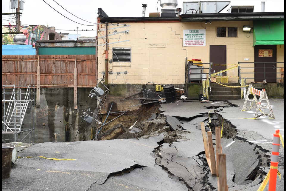 On Jan. 31, the retaining wall of a construction site came down during heavy rainfall on, causing a section of the Congee Noodle House parking lot to cave in and slide into the neighbouring excavation pit. Photo Dan Toulgoet