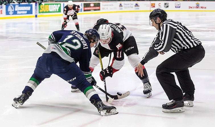 Citizen Photo by James Doyle. Prince George Cougars forward Josh Maser faces off against Seattle Thunderbirds forward Henrik Rybinski on Tuesday night at CN Centre.