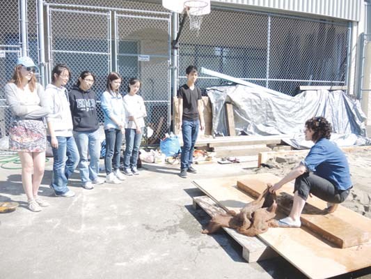 McRoberts students work with local artist Jasmine Reimer to install public art in the back lot of their school.