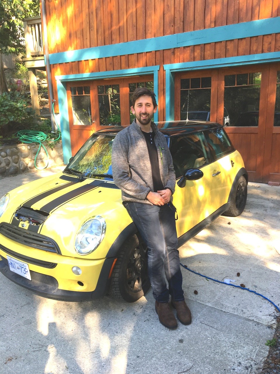 Will McKnight poses with a 2003 Mini Cooper