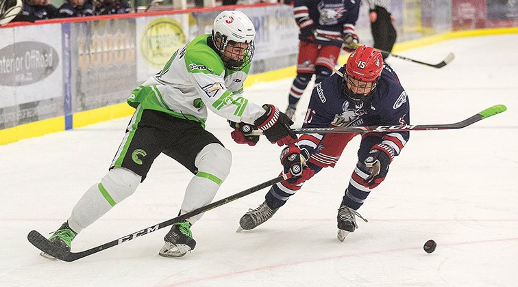 Cariboo Cougars forward Jackson Hassman battles for the loose puck with Greater Vancouver Canadians defender Jaden Procter on Saturday afternoon at Kin 1.