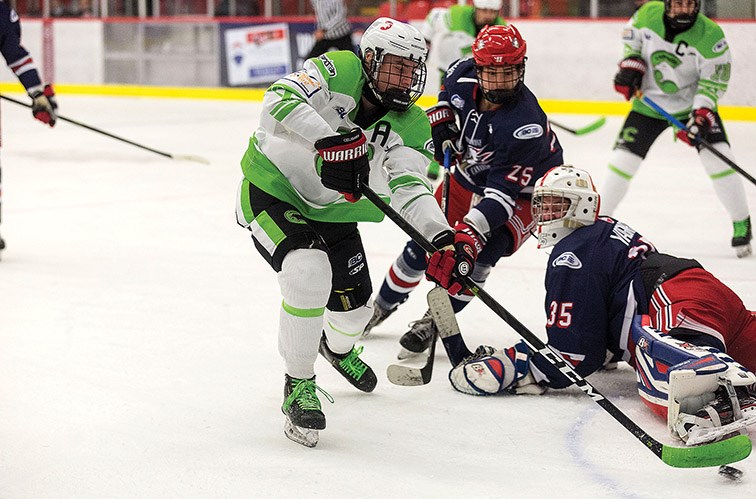 Cariboo Cougars forward Brennan Bott tucks the puck into the net past Greater Vancouver Canadians goaltender Justin Wagner in a Feb. 8 game played at Kin 1.