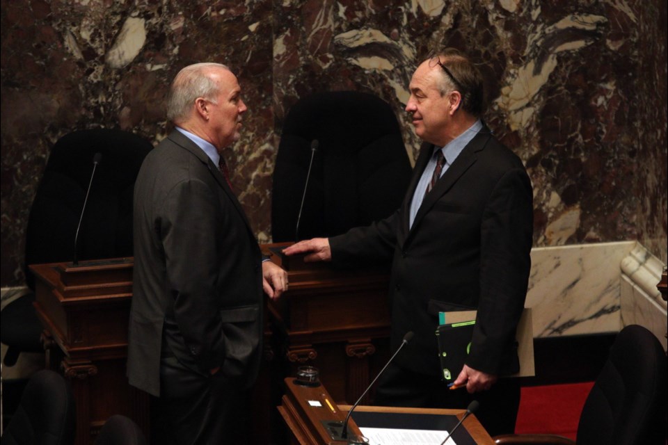 Premier John Horgan and Independent MLA Andrew Weaver talk before Lt.-Gov. Janet Austin delivers the throne speech on Tuesday. Feb. 11, 2020