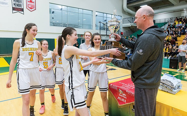 Citizen Photo by James Doyle. The Duchess Park Condors captains receive their trophy and banner after claiming their seventh consecutive Prince George Senior Girls High School Basketball City Championship after defeating the PGSS Polars by a score of 87-34.