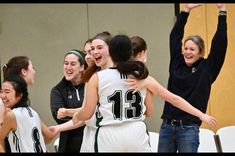 The Delta Pacers celebrate their huge win over Steveston-London, including longtime coach Kerrie Trotman (far right) that clinched a berth in the upcoming provincial 3A girls basketball championships at the Langley Events Centre.