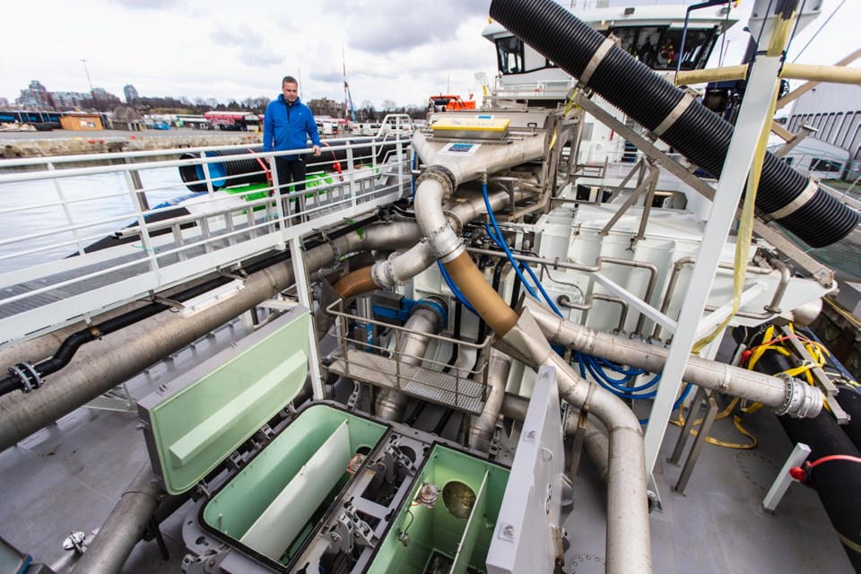 Nick Knickle, captain of the Ronja Islander, inspects some of the piping on the systems that bring fish aboard and deliver them back to pens after sea lice are removed.