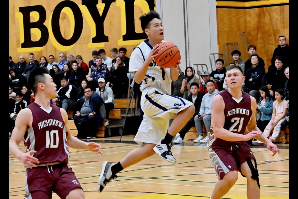 Steveston-London's Nao Kawano soars to the basket in his team's 75-65 semi-final win over the Richmond Colts at the Richmond Senior Boys Basketball Championships on Thursday night at Hugh Boyd. The Sharks will face the McMath Wildcats in next week's final.