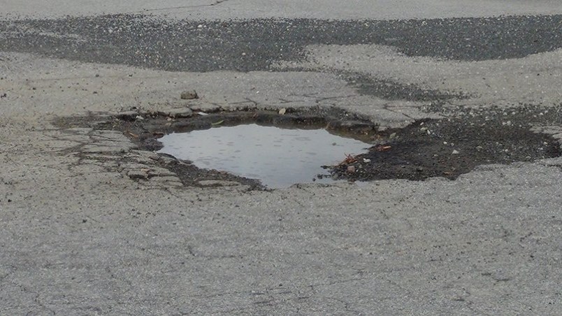 Pothole fills up with rain