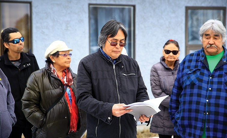 Former Yekooche chief Matthew Joseph, centre, addresses the media in front of the Yekooche First Nation Finance Office on Friday morning.