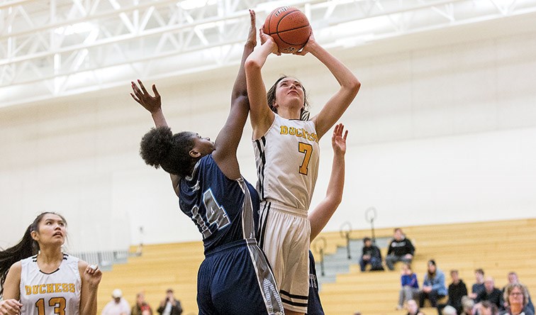 Citizen Photo by James Doyle. Duchess Park Condors player Jasmin Schlick leaps to take a shot against College Heights Cougars defender Sam Harris on Friday afternoon at Duchess Park gymnasium during the “A” Final of the 2020 North Central Zone AAA Girls Basketball Championships.