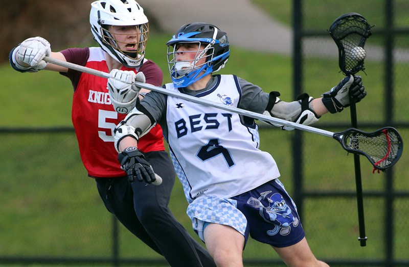 MARIO BARTEL/THE TRI-CITY NEWS
Dr. Charles Best Blue Devils forward Ryan Favaro tries to get around a St. Thomas More Knights defender in the first half of their BC High School Lacrosse League game, last Wednesday at Best field. The Blue Devils won, 12-2.