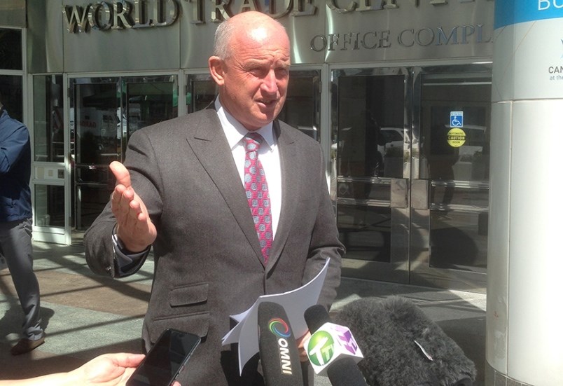 Mike Farnworth speaks to media at an unrelated event