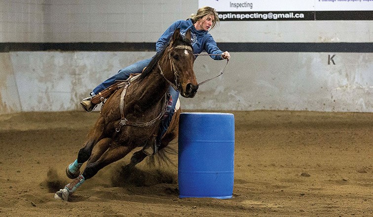 Citizen Photo by James Doyle. A horse and rider make their way around the barrels at the Prince George Agriplex on Friday night during the Prince George Rodeo Association’s Valentines Barrel Race.