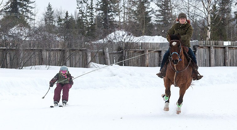 Citizen Photo by James Doyle. A skier is pulled by a horse and rider on Sunday morning at the Prince George Rodeo Grounds during the second annual Skijoring PG event