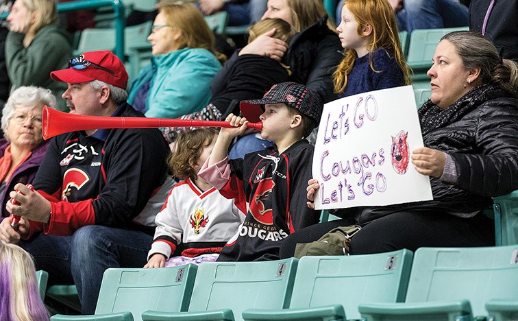 A young Prince George Cougars fan blows a horn in support of the team during their game against the Red Deer Rebels on Monday afternoon at CN Centre.